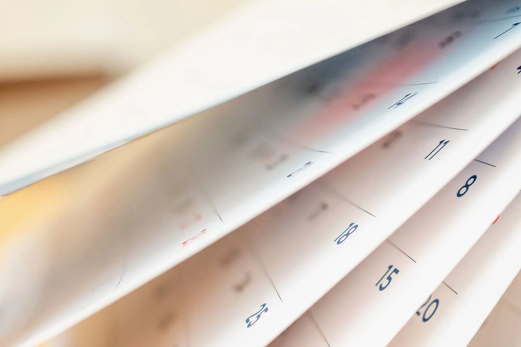 An open calendar with its pages fanned out and dates visible.