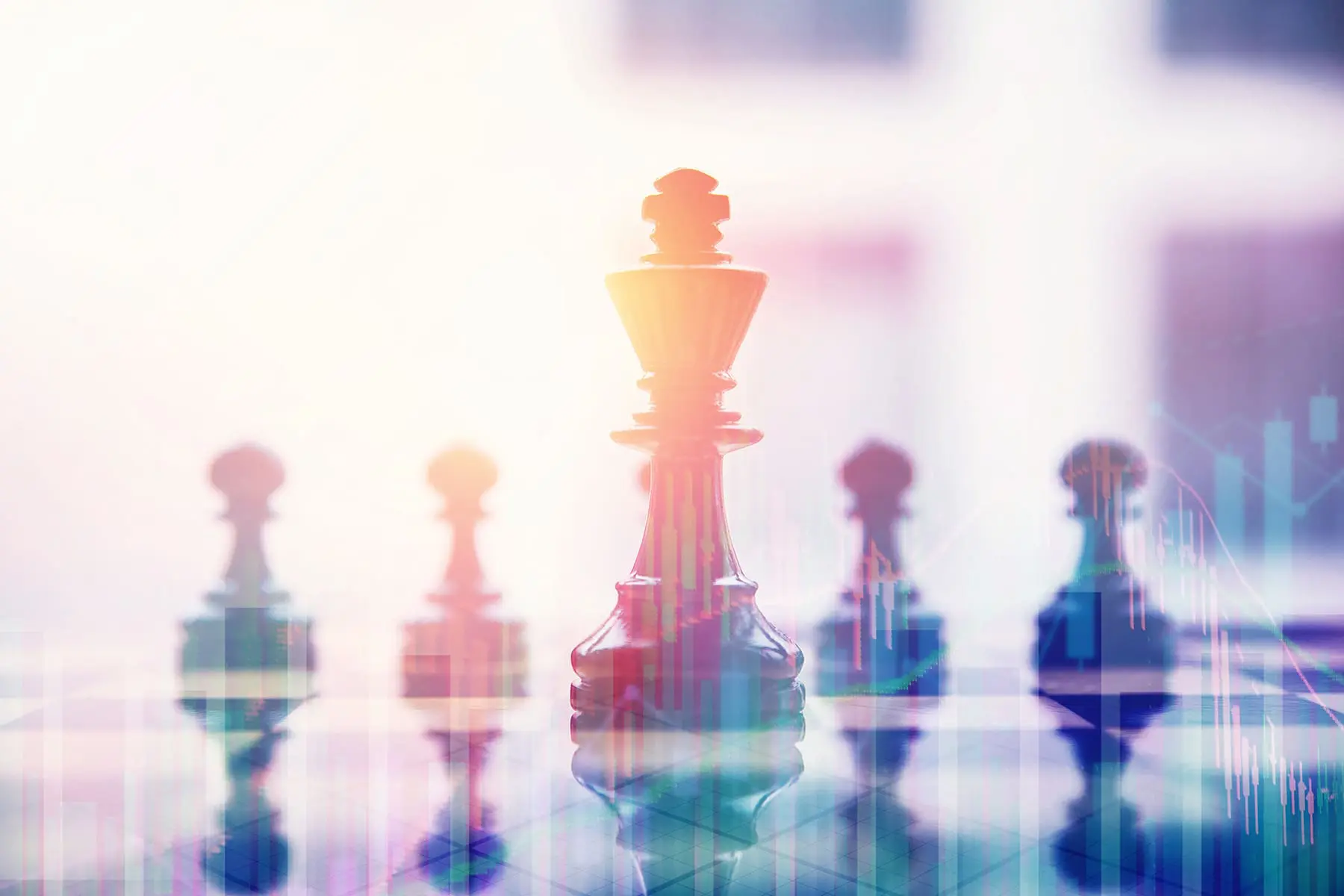 Several chess pieces are arranged on a reflective surface, with a prominent king piece in focus and a bright, abstract background.