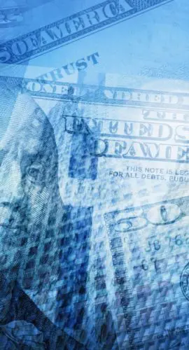 Overlay of U.S. $50 and $100 bills in blue tones with the silhouette of high-rise financial institutions in the background.