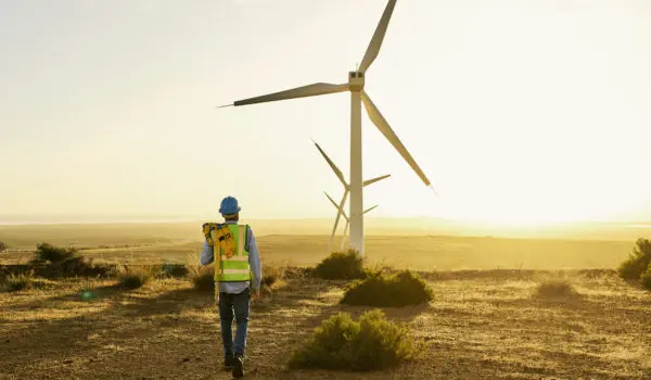 Engineer, wind turbine and clean energy with electricity and environment, sustainability and natural with technology. Renewable, engineering with agriculture, man and windmill inspection and mockup