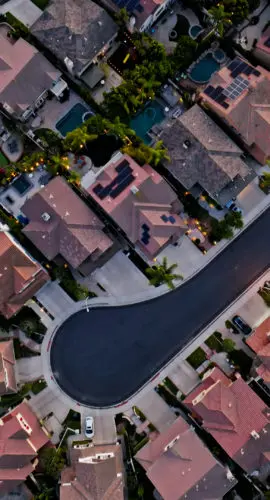 Top down aerial shot of residential streets in Tustin, a city in Orange County, California, at sunset.