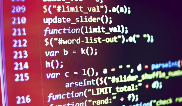 A close-up view of a computer screen displays a colorful code editor with various lines of programming code.