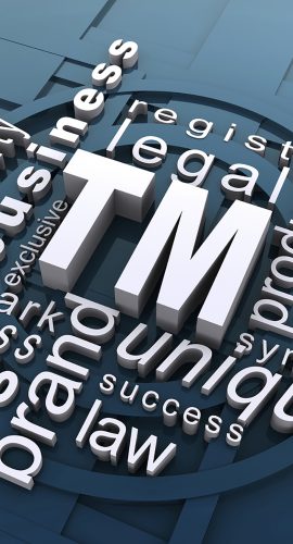 A 3D conceptual art of various words such as "legal," "trademark," "symbol," and "law" interconnected around a central "TM" logo, representing elements related to trademark law on a blue background.