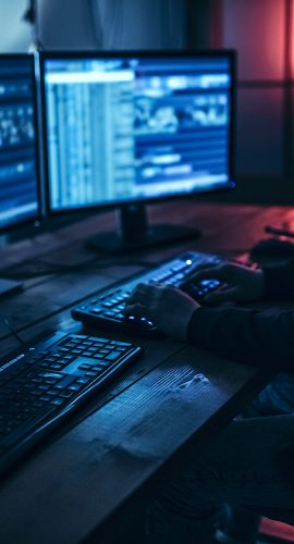 hacker in dark room behind data breach