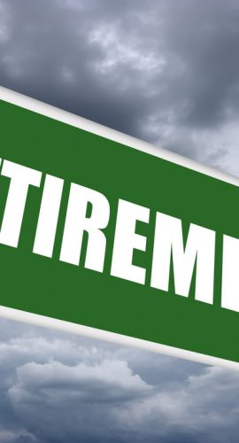 A green road sign with the word "RETIREMENT" on it against a cloudy sky backdrop.