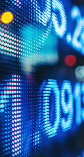 Display Stock Market Numbers With Defocused Street Lights Background