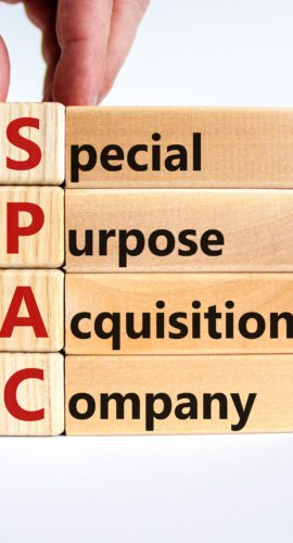 SPAC, special purpose acquisition company symbol. Businessman holds cubes with words 'SPAC' on beautiful white background, copy space. Business and SPAC, special purpose acquisition company concept.