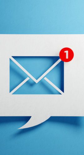 White chat bubble with email symbol on blue background. Horizontal composition with copy space.