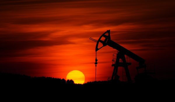 Pump-jack mining crude oil with the sunset