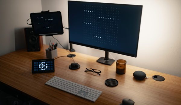Computer with various electronic devices and speaker placed on table