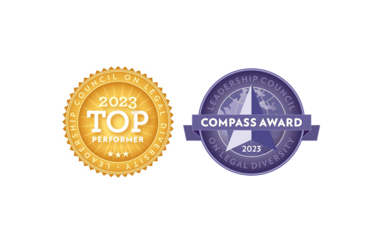 Two award badges from the Leadership Council on Legal Diversity for 2023: a gold Top Performer badge and a blue Compass Award badge.