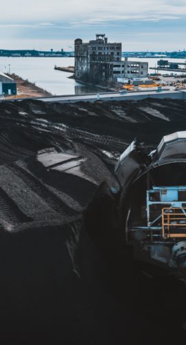 Machine digging coal in industrial area