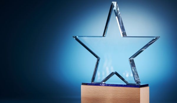 Glass trophy on blue background