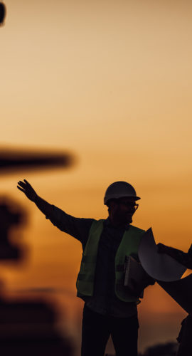 Silhouette of Survey Engineer and construction team working at site over blurred industry background with Light fair Film Grain effect