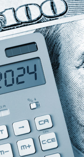 2024. Benjamin Franklin looking calculator on One Hundred Dollar Bill.