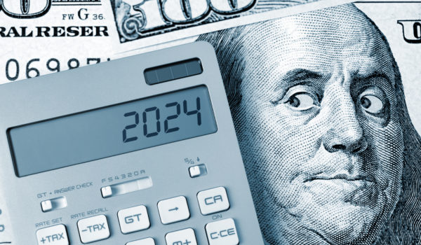 2024. Benjamin Franklin looking calculator on One Hundred Dollar Bill.