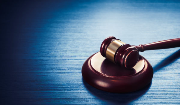 high contrast image of Judge gavel on a blue wooden background