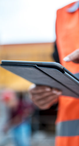 Two architects are using digital tablet on construction site.