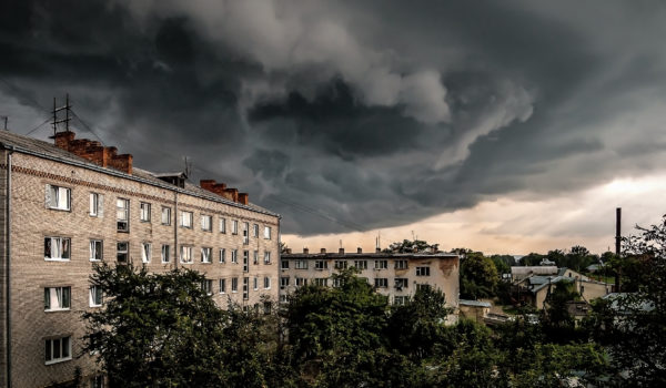 Amazing dark stormy tornado clouds over the apartment building in the city