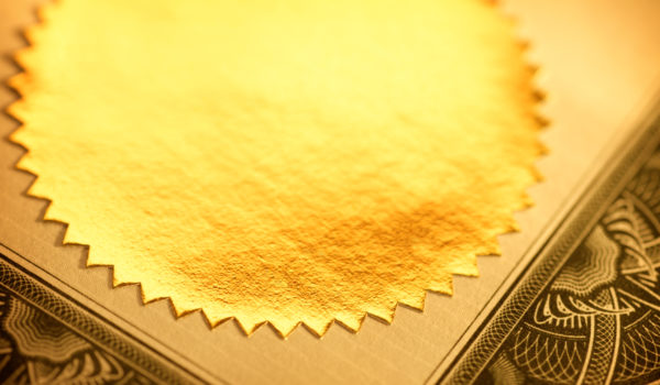 Close up of a gold seal on a certificate.