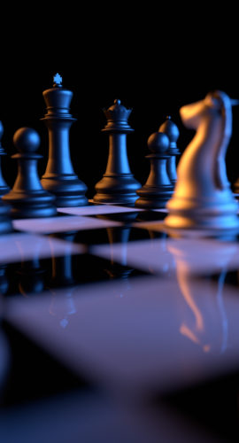 Close up of chessmen on chessboard with the focus on a queen