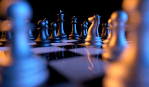 Close up of chessmen on chessboard with the focus on a queen